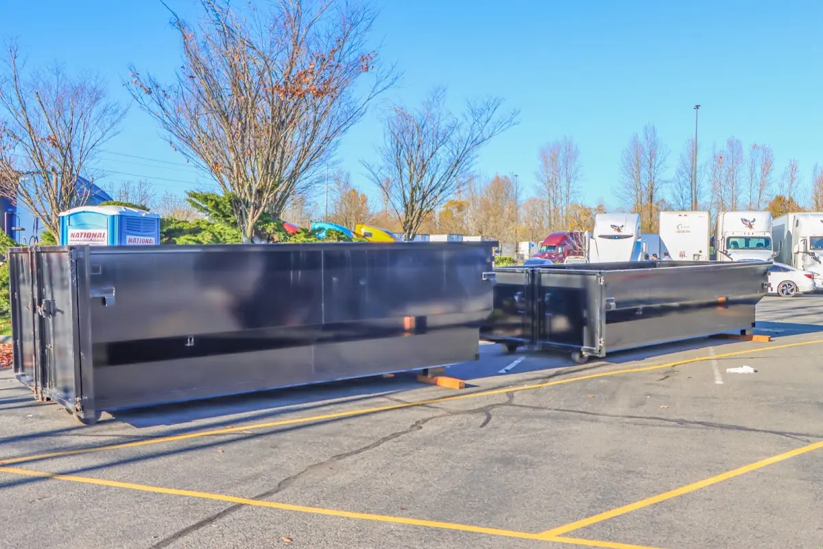 Professional dumpster rental service with roll-off container on residential driveway in White Marsh